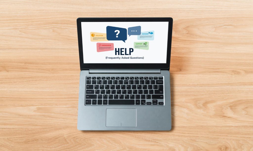 FAQ help page displayed on a laptop screen with real customer questions