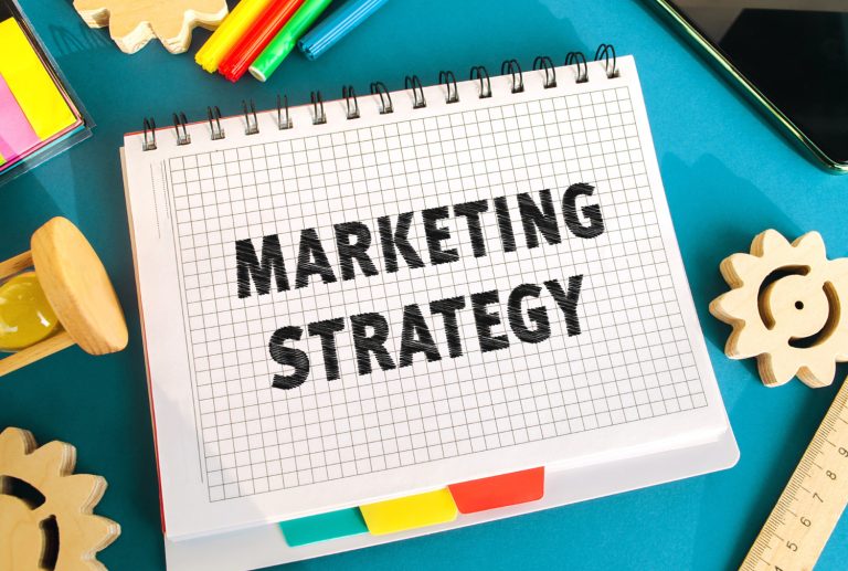 Marketing strategy notebook with weekly SEO check notes on a desk